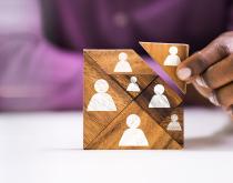 Business person adding game piece
