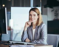 Business woman in front of laptop smiling