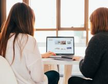 Two women working on website