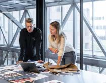 Woman and man collaborating in an office with laptop