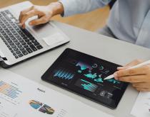 Worker looking at economic data on screen