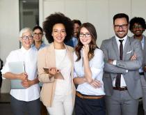 Diverse group of employees smiling for camera