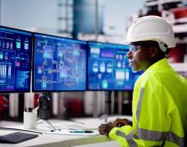 Manufacturing worker watching production screen