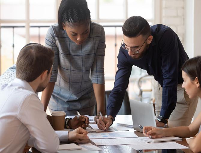 Multiracial group planning business finances