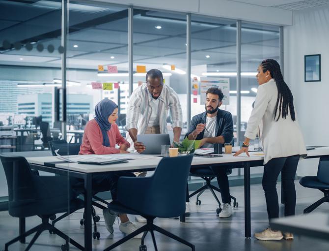 Employees working around conference table