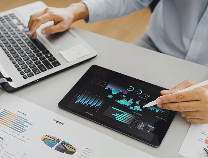 Worker looking at economic data on screen