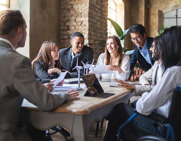 Diverse employees talking around a table