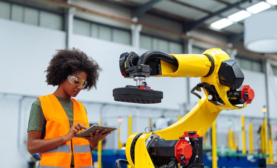 Woman working with robotic arm